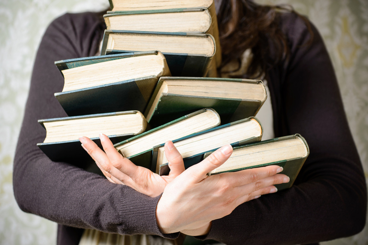 A Student Holding Old Books