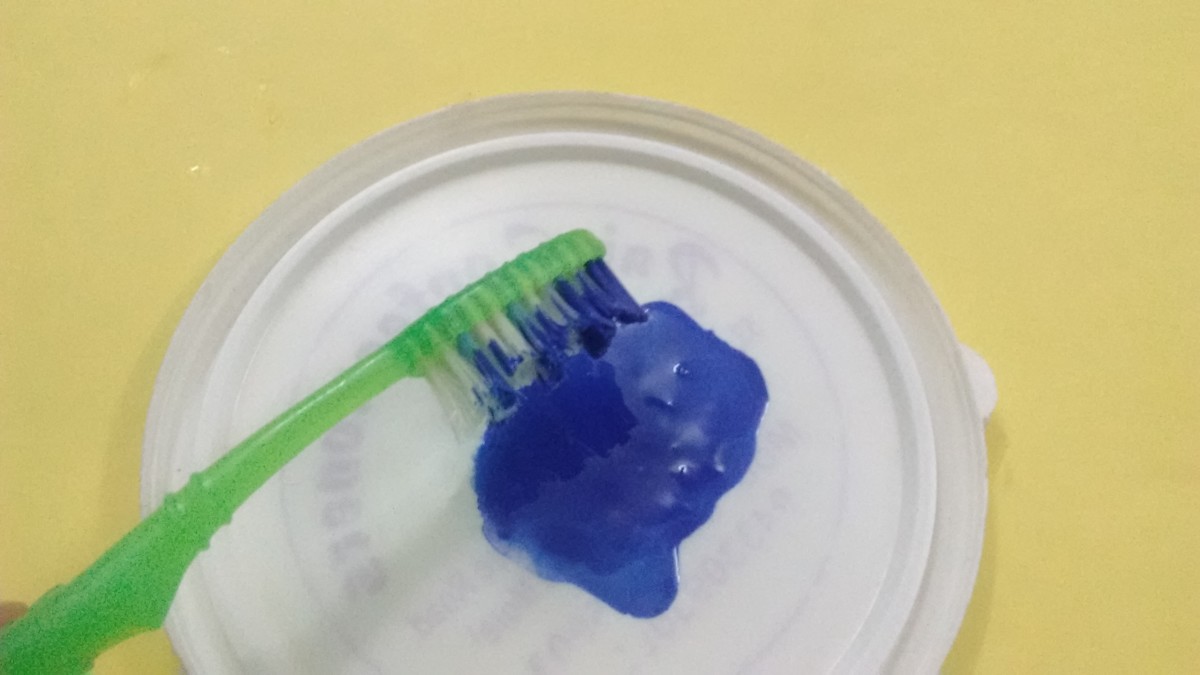 Now dip the toothbrush in the paint.  
