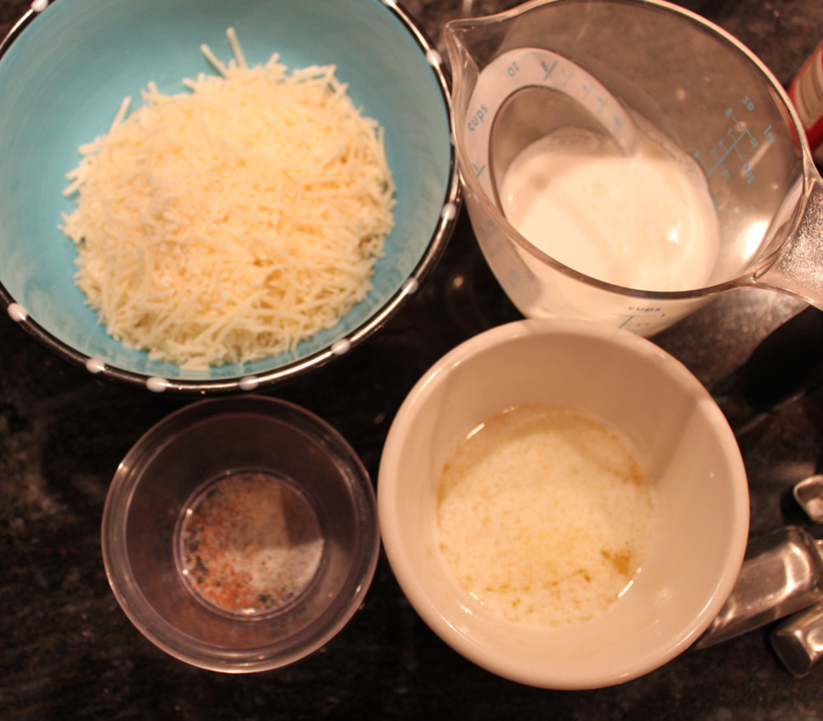 Measure out your ingredients to start.  Clockwise from upper left:  Parmesan cheese, cream, melted butter, spices.