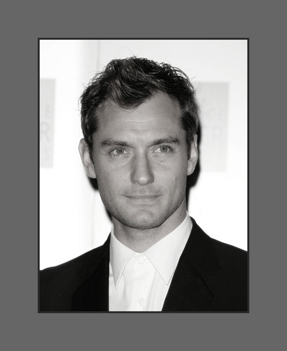 Jude Law's hair is cut in layers short on the side and longer in top and styled with a soft wave covering a little of the forehead  - 2013 Hairstyles for Men with Balding Thinning Hair Style Cuts Trends