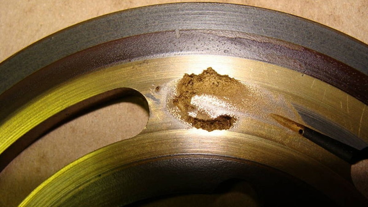 Cavitation damage on the valve plate for an axial piston pump.