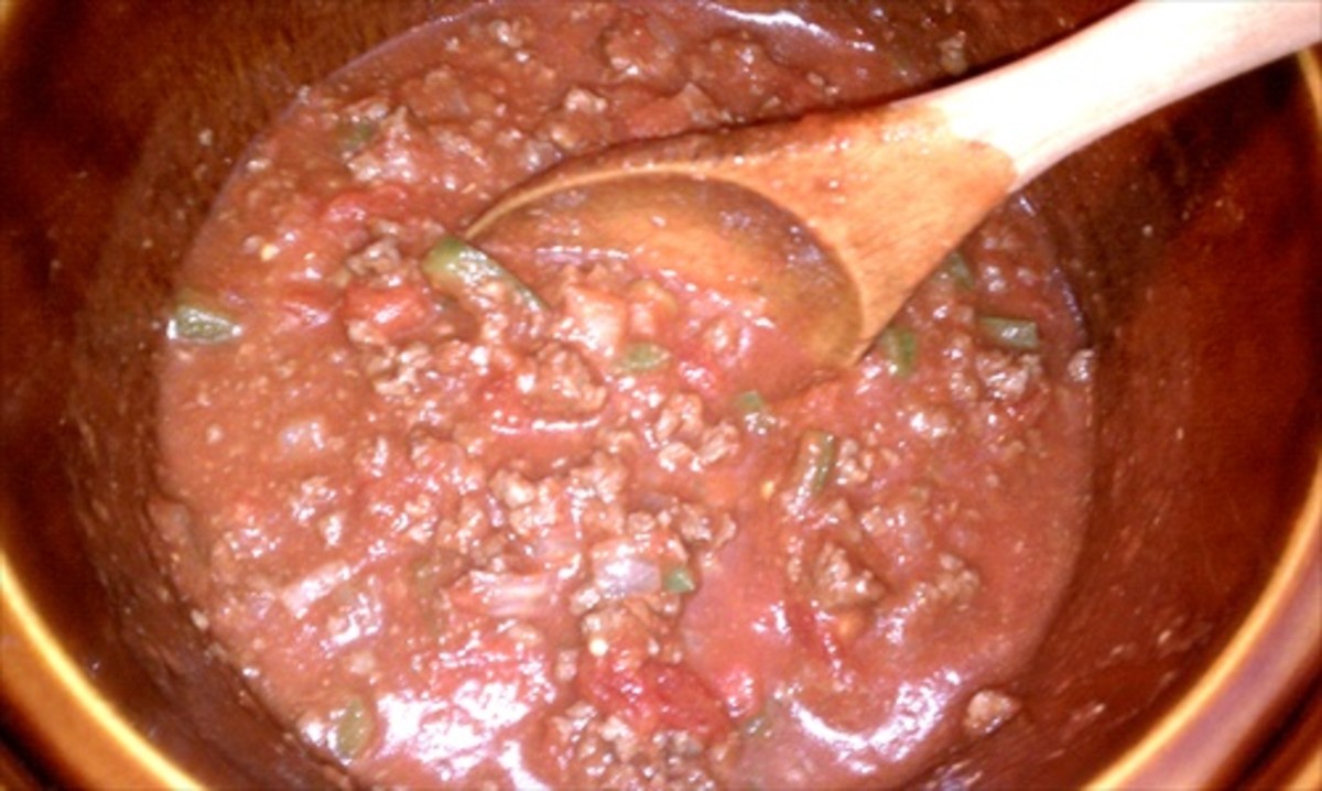 Combine cooked meat with tomatoes in a large pot or crock pot.  Then add macaroni and simmer.