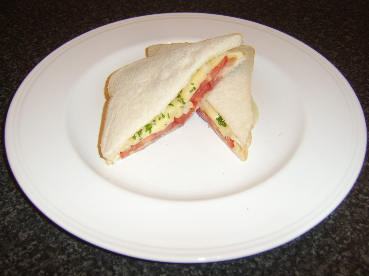 Crispy bacon, sliced tomato and onion, with melted cheddar cheese and chives sandwich