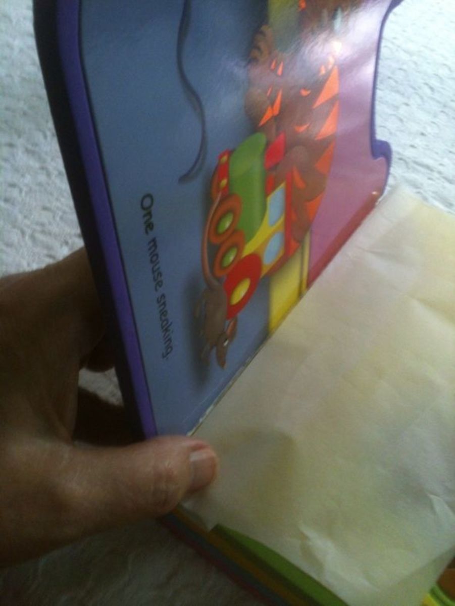 Using waxed paper for spine repair on a book.