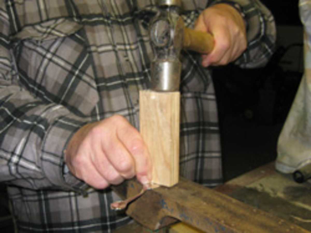 The first step is to hammer the teaspoon part flat. Use a block of wood on softer metals to prevent marking.