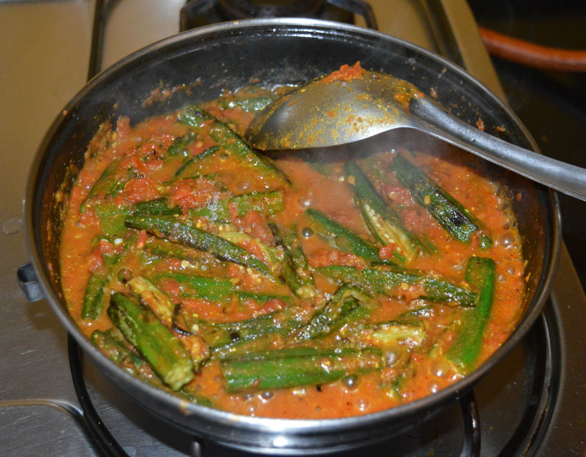 Step five: Reduce the heat and add okra. Stir the mixture well. 