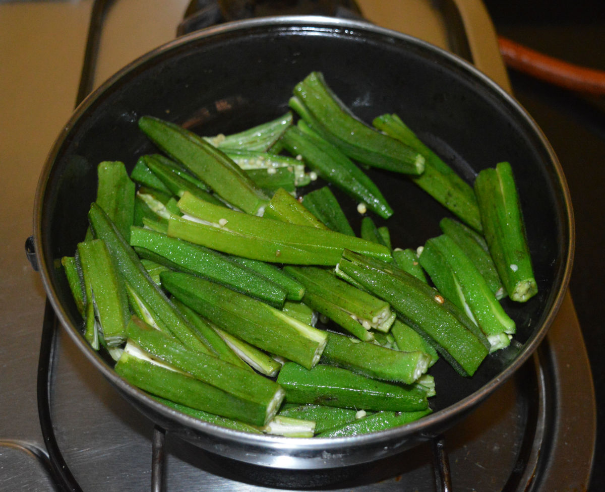Step one: Wash okra and pat dry them with a cloth. Chop both ends. Cut long okra into two. Let the small okra be as is. Lightly slit them three-quarters of the way down the length.