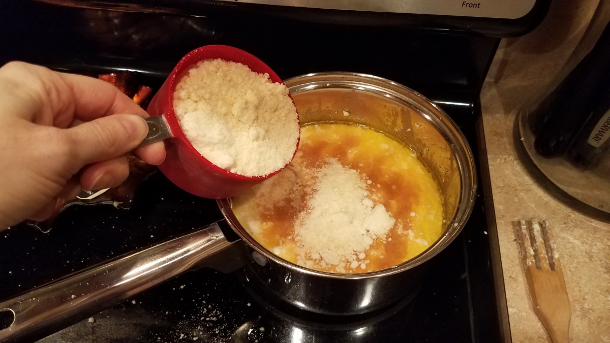 And finally, add your grated Parmesan. Whisk together and let thicken, stirring every so often, so it doesn't burn to the bottom.