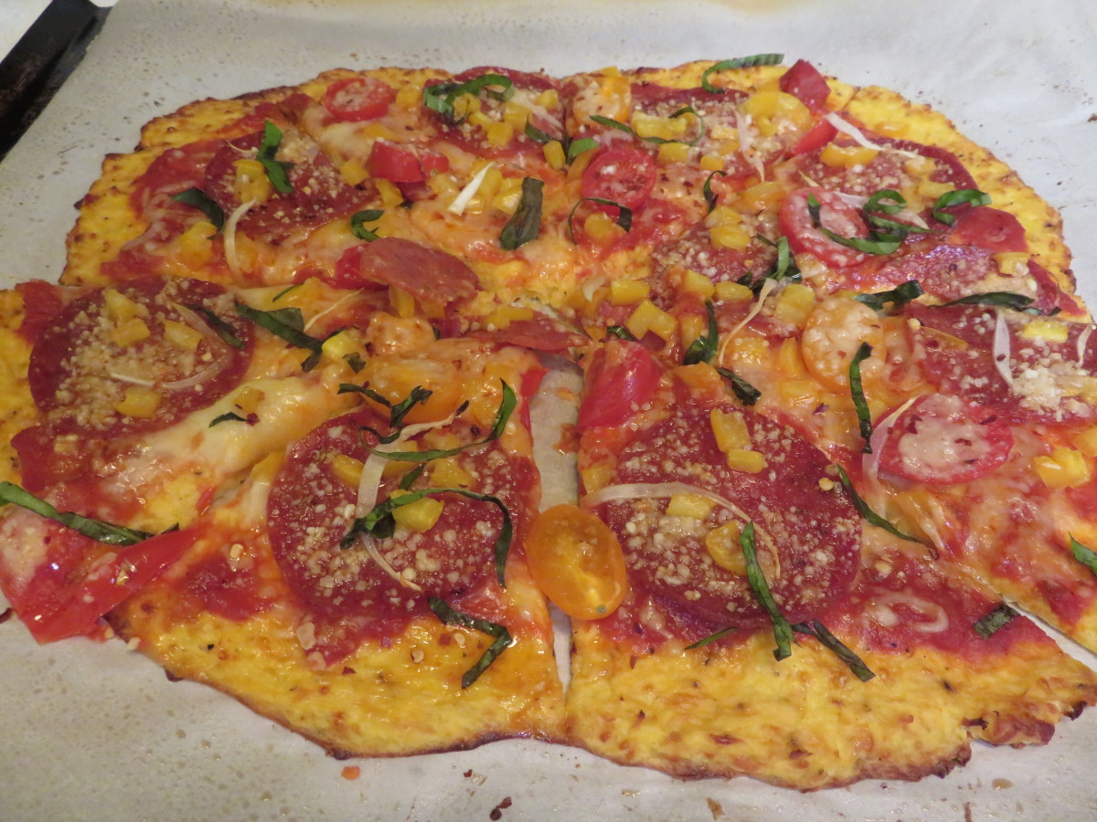Sliced pizza out of the oven with the basil and red pepper flakes as a finishing touch.
