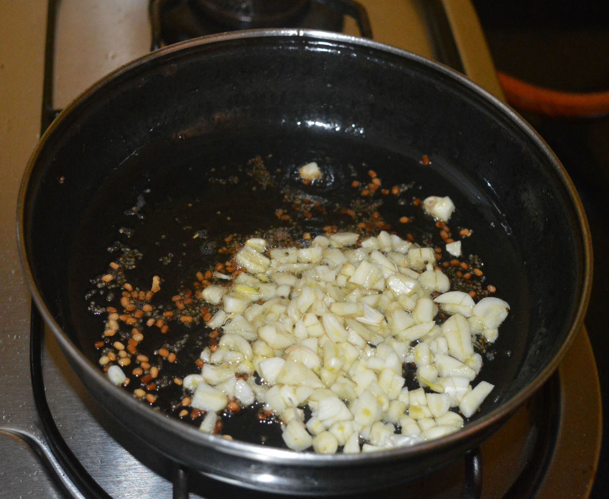Add chopped garlic. Saute on low flame until the garlic becomes crunchy and lightly brown.