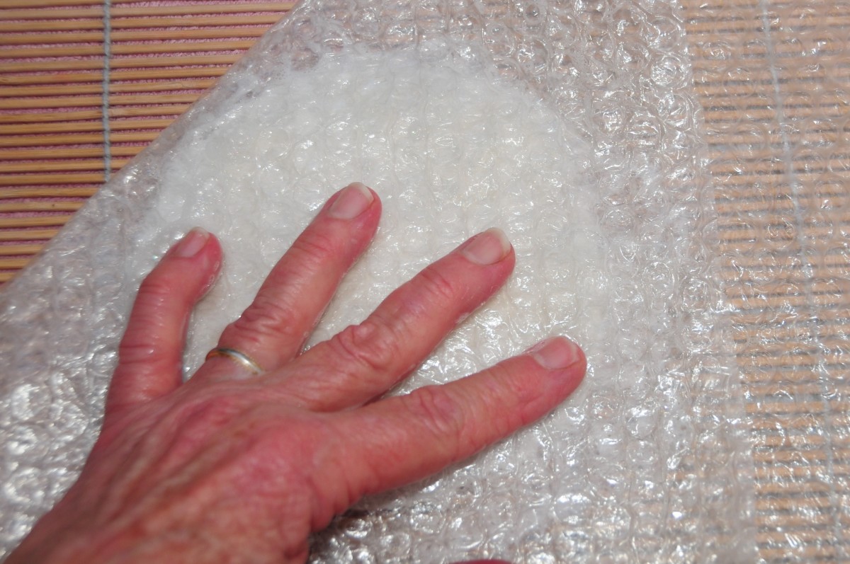 Rub the wet fibers under the bubble wrap until they have flattened.