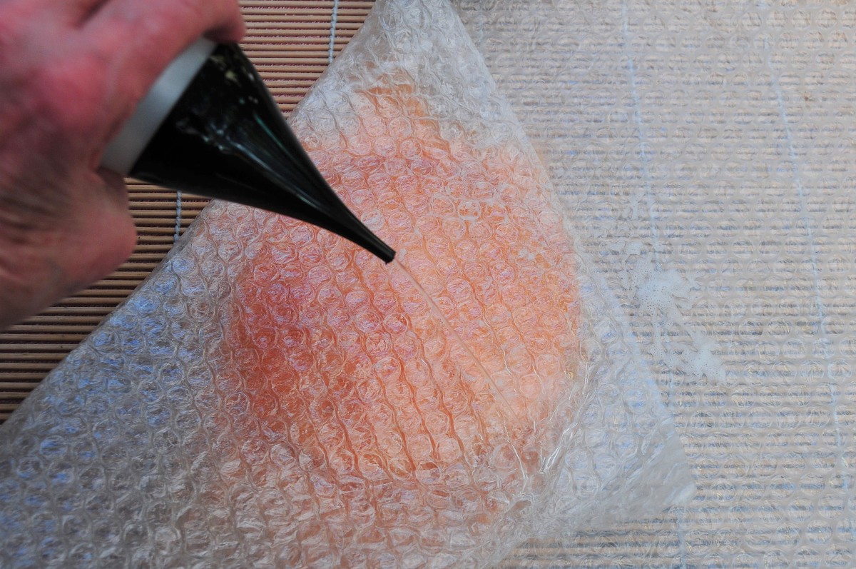 Cover with bubble wrap and wet the surface.