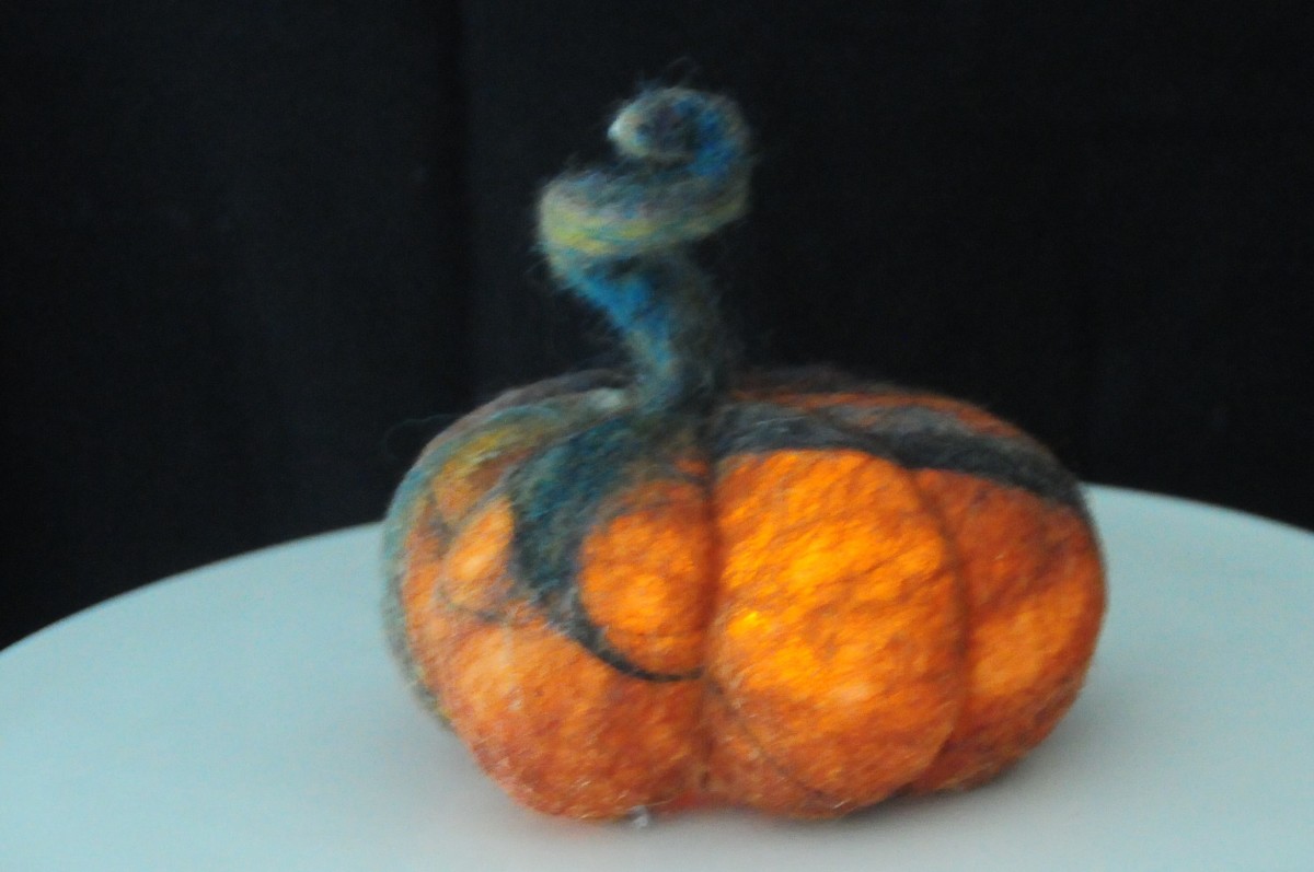The completed pumpkin with battery-operated tea light glowing inside