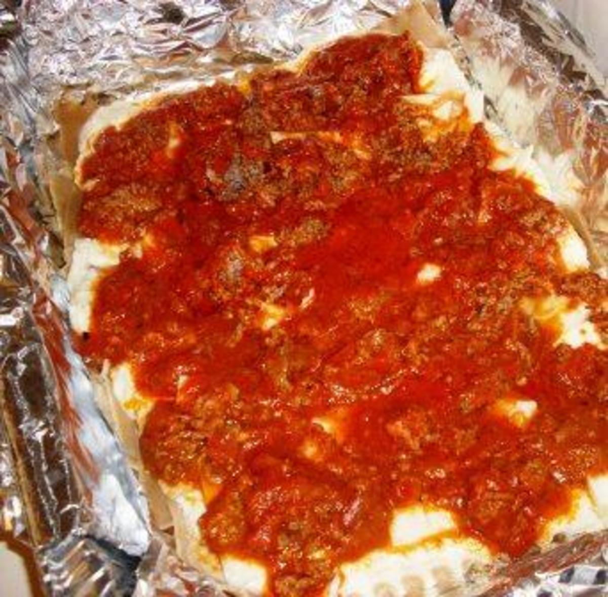 layer the meat sauce on top of the cheese mixture