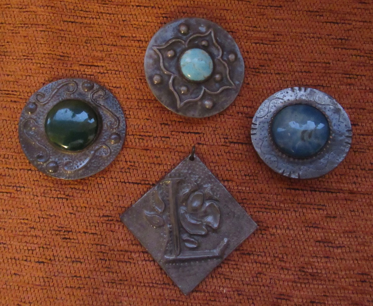 3 of Mum's brooches and the 'L' medallion