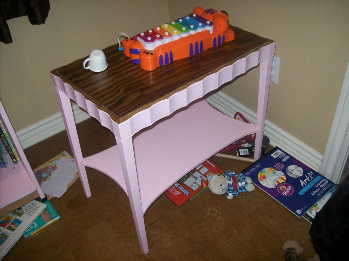 Another $5 Goodwill purchase. Inlay 1/4" plywood top, right angle brackets to secure the legs, and plenty of pink paint.