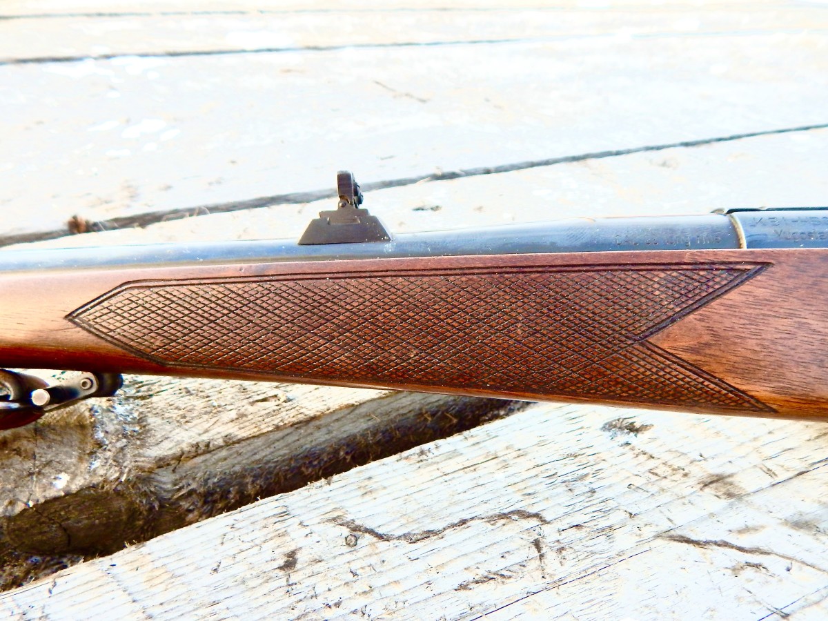 View of the very nice, hand cut checkering on the walnut stock.