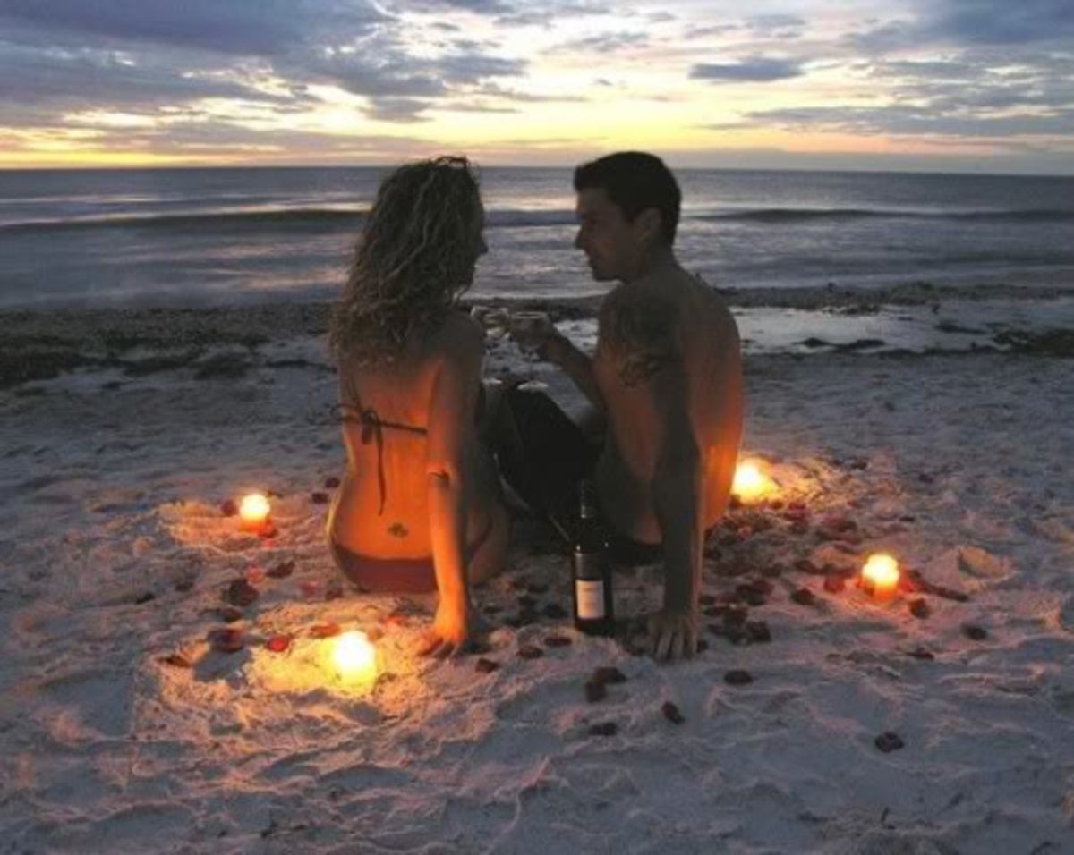A Couple Enjoys a Romantic Date on the Beach at Sunset.