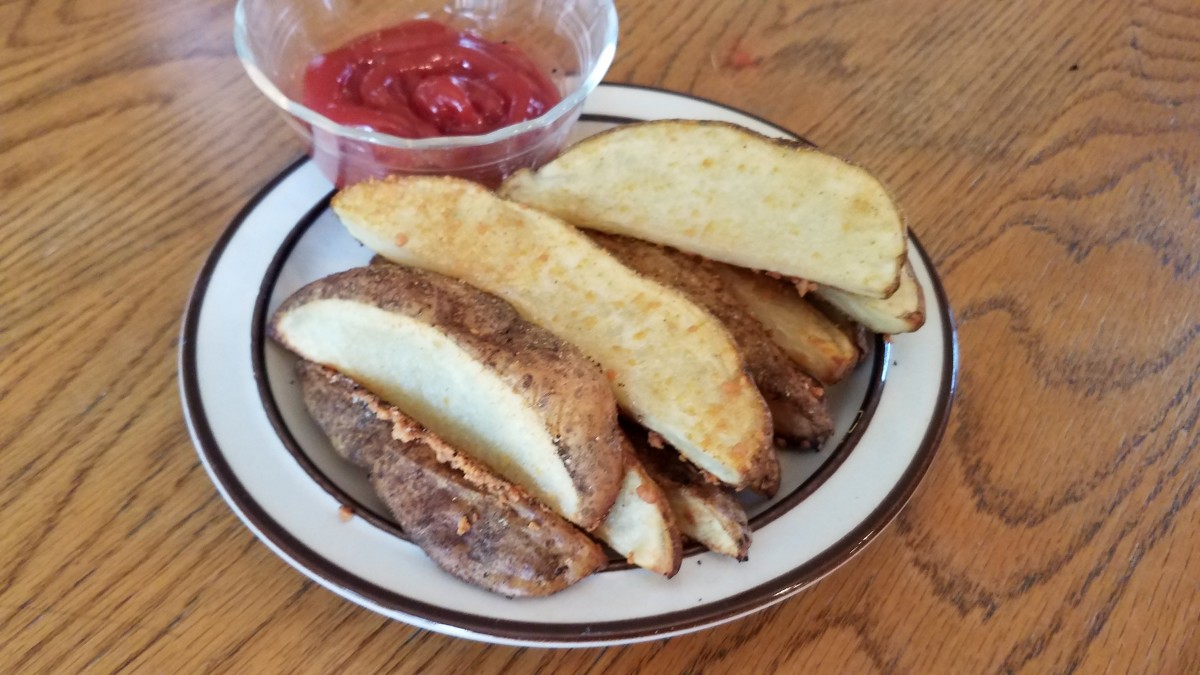 A plated serving of my crunchy garlic potato wedges with ketchup for dipping