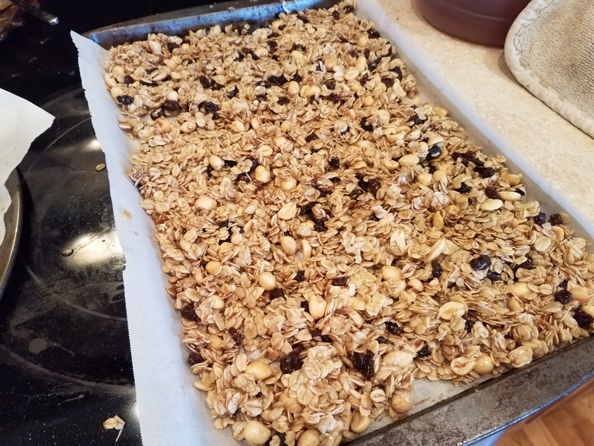 Spread the granola mixture out in a thin layer on both of your cookie sheets.