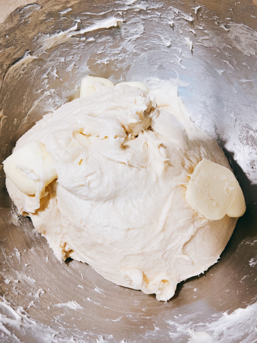 Continue adding the remaining butter to the bowl and increase the speed to medium for 2 minutes or until the mixture forms a dough.