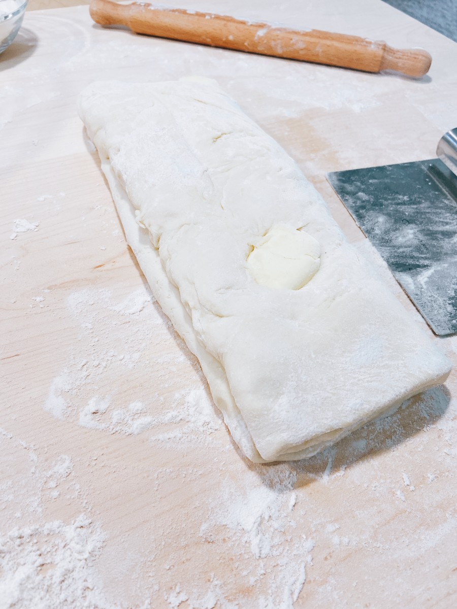Fold the dough in half at the point where they meet.