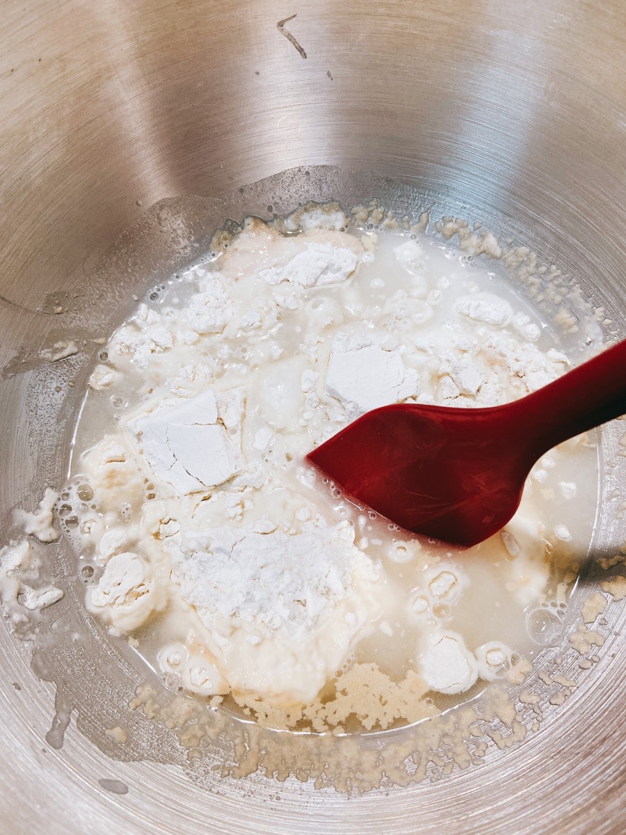 Make the sponge: In a mixing bowl, combine the warm water, flour, and yeast. Combine the mixture evenly by using a spatula. Let it sit for 5 minutes.