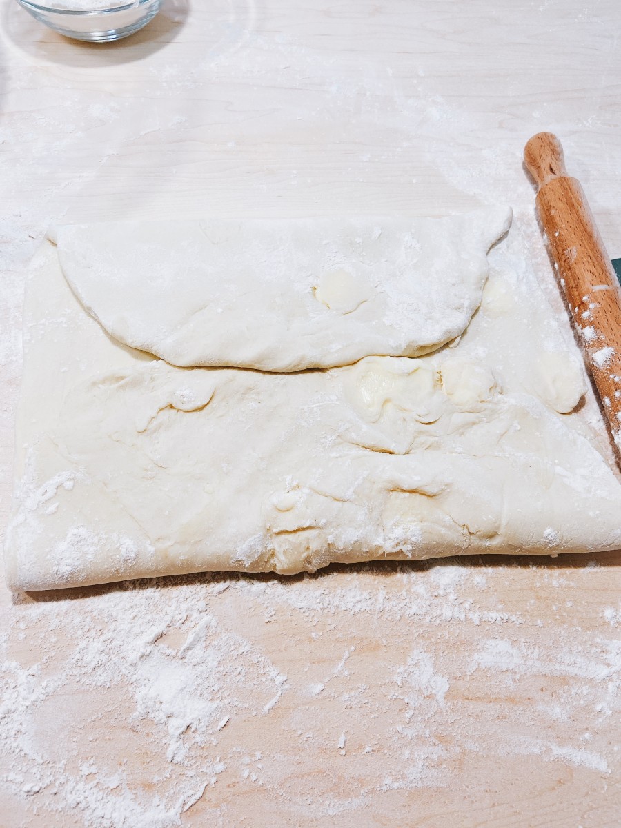 Bring the two short ends of the dough to meet in the center. 