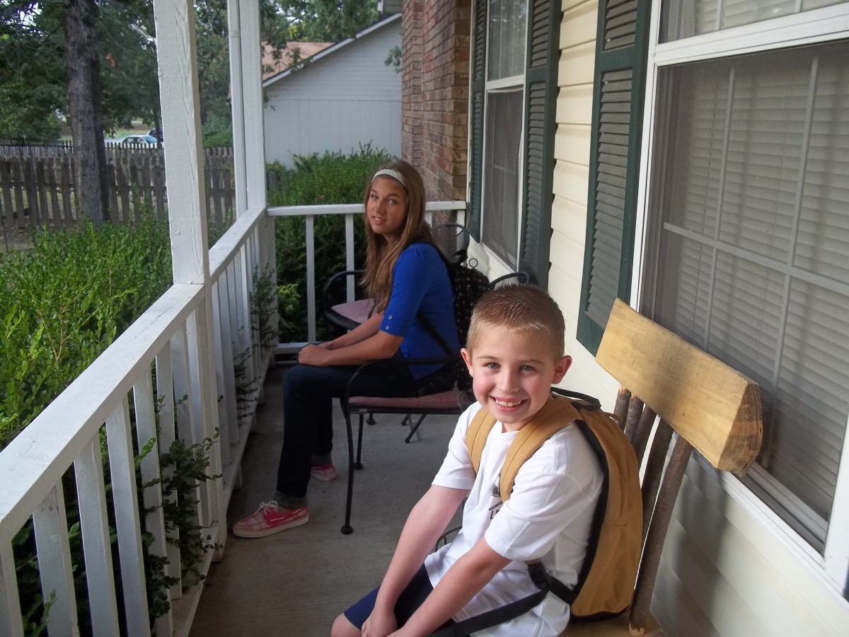 Lil' Britches and sis waiting on the bus for his first day of school