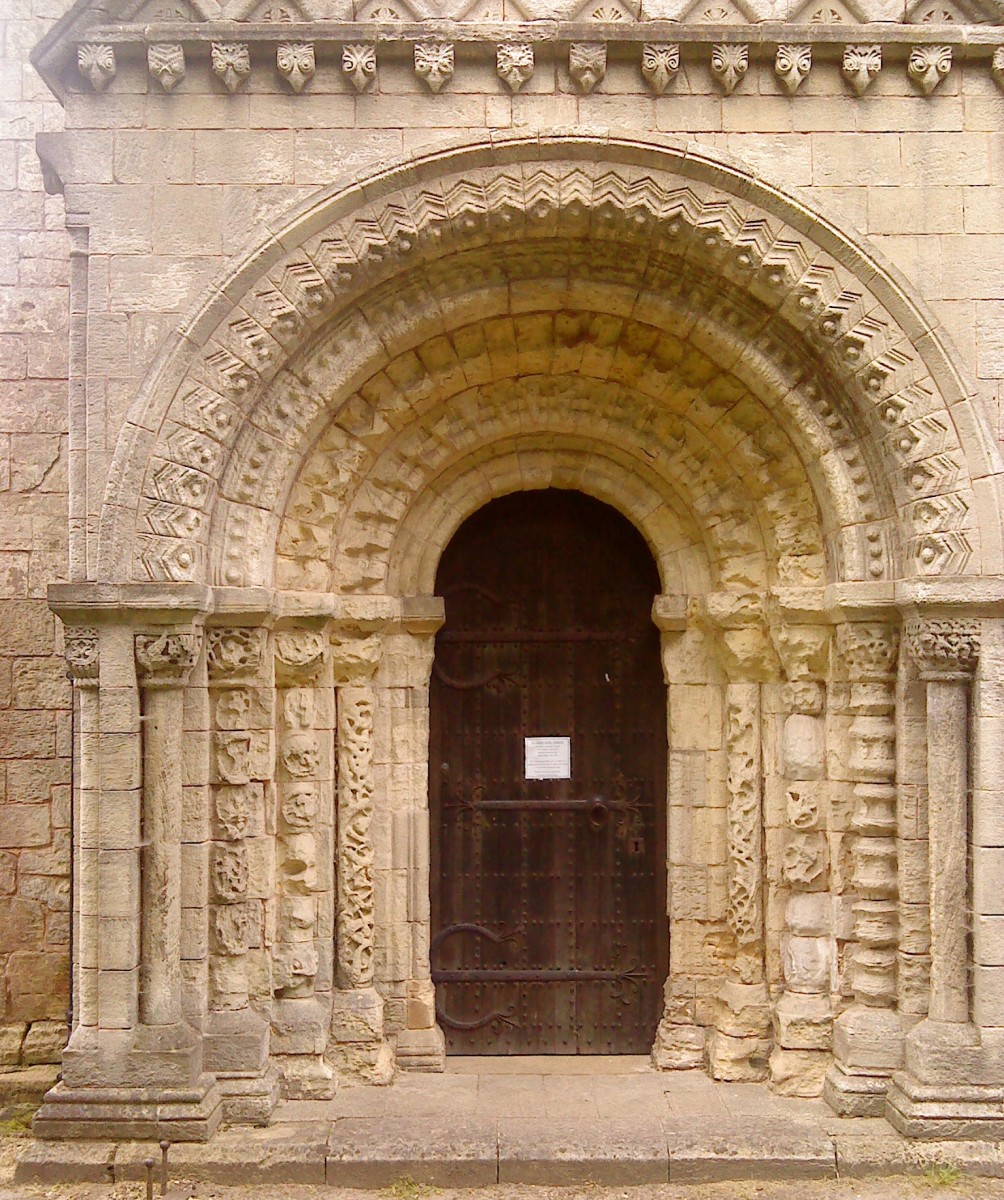 The ornate stone carvings around the entrance door. Animals, plants and symbols in various patterns give a depth to the archway.