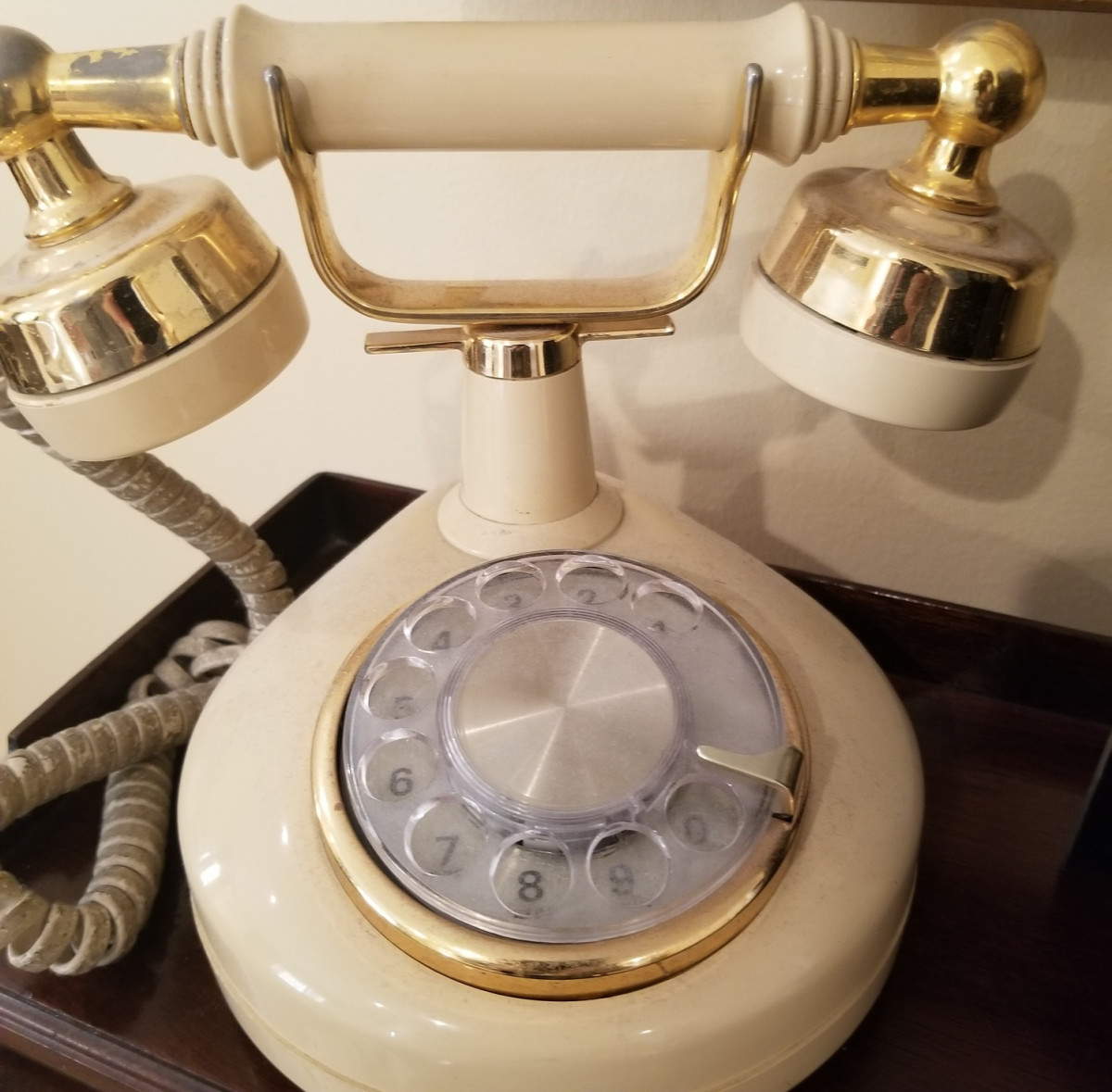This is a reproduction, but notice the rotary style numbers of this landline. My phones are all push button, but I seldom use anything but automatic dial now.