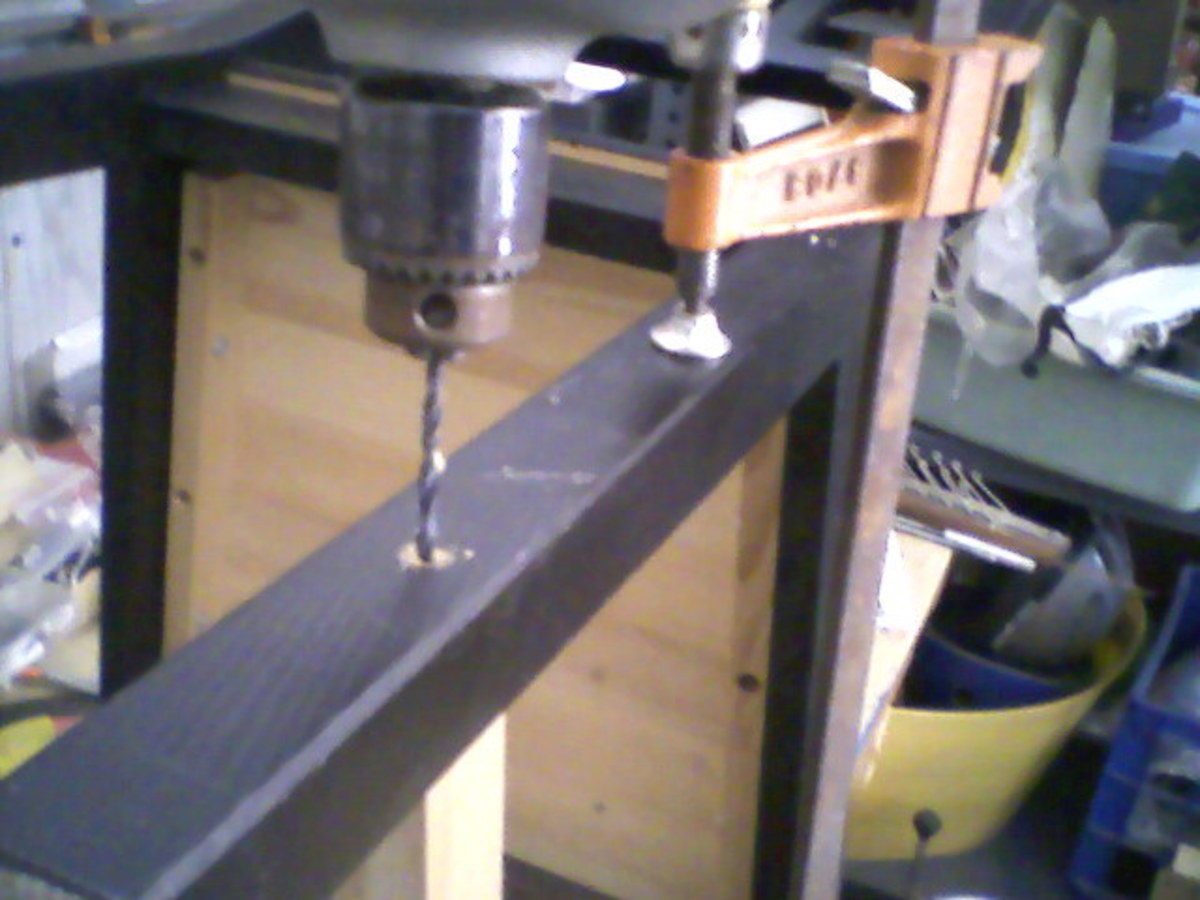 Drilling back into brace end.  Note use of bar clamp to help secure the brace for drilling.
