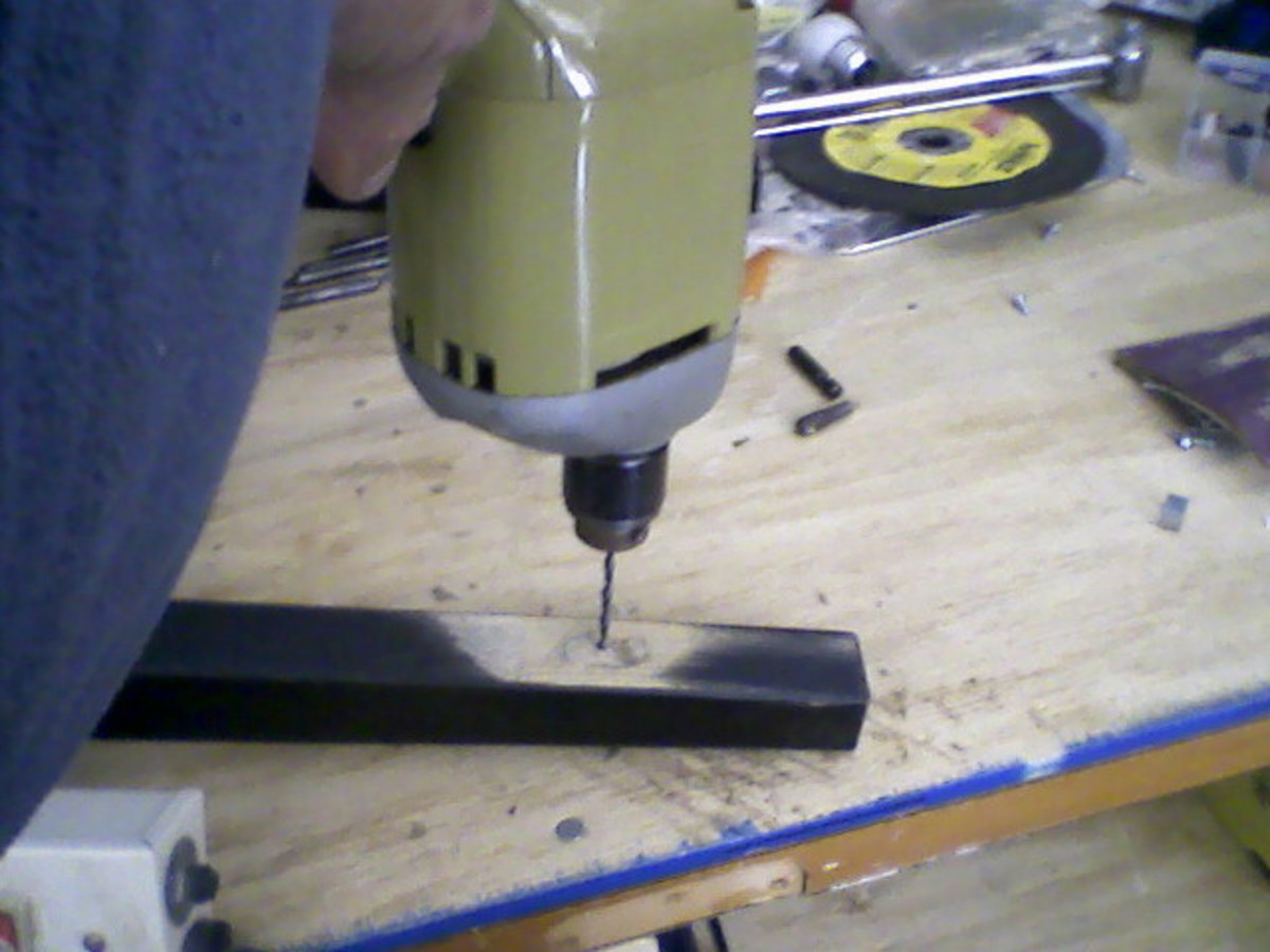 Drilling a pilot hole from the inside surface out.