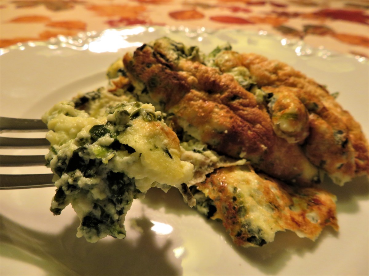 A fork full of light and flavorful spinach and goat cheese soufflé