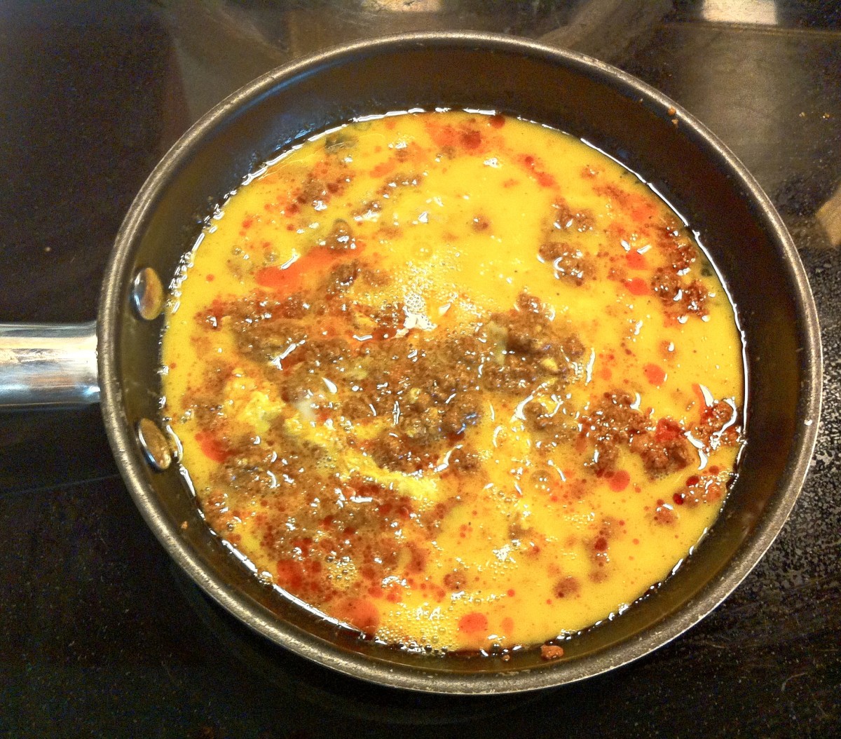 Add eggs to chorizo and cook until the eggs are set.