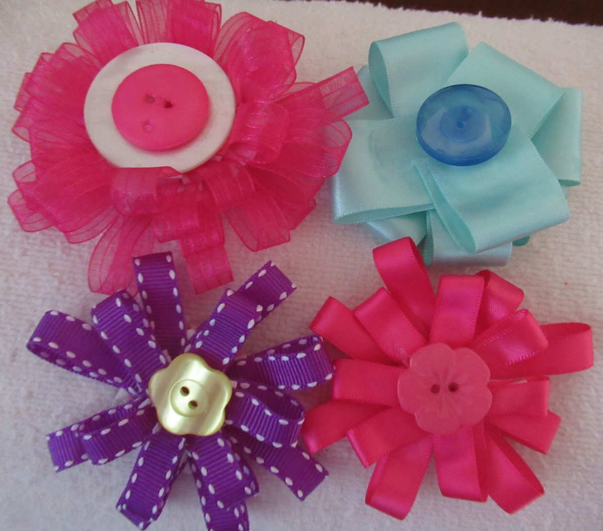 I meds these ribbon flowers from ribbon in my stash. Easy to make ~
