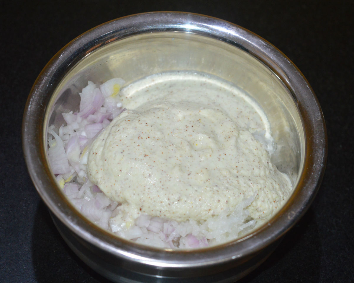 Add the coconut paste to the bowl containing grated radish and chopped onions.