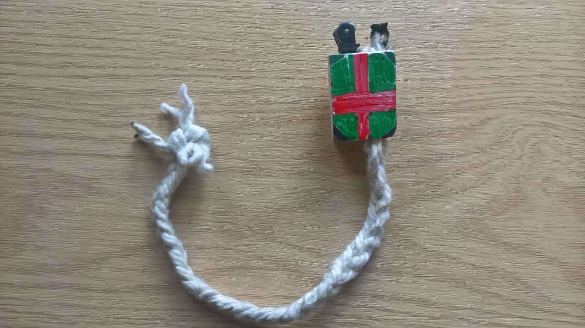 A small block of wood with two holes design