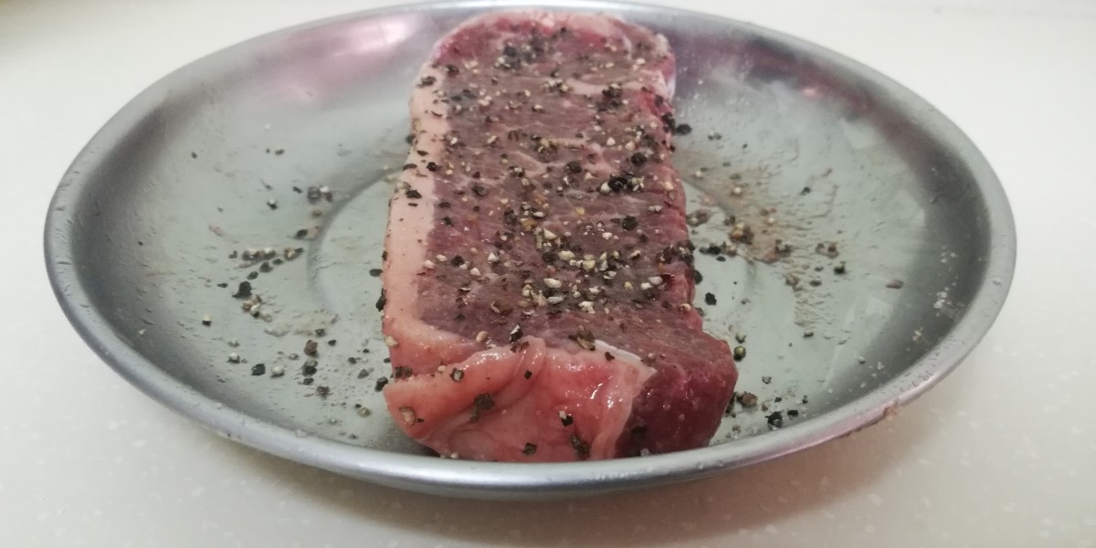 My Strip-loin steak after a dry brine and adding black pepper. 