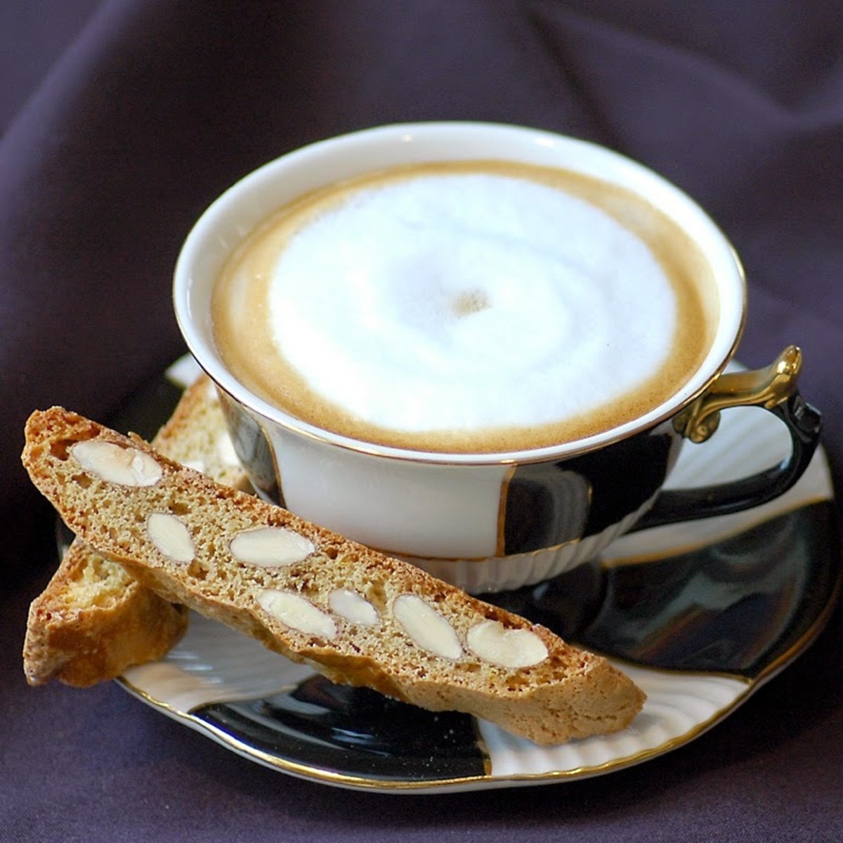 The crunchy biscotti dunks in the capuccino coffee cup.