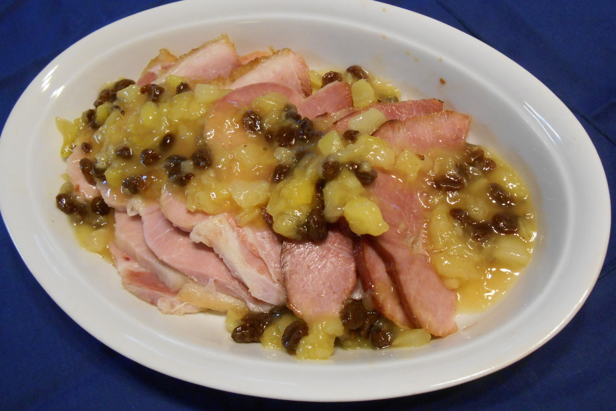 Baked Ham topped with Pineapple Raisin Sauce.