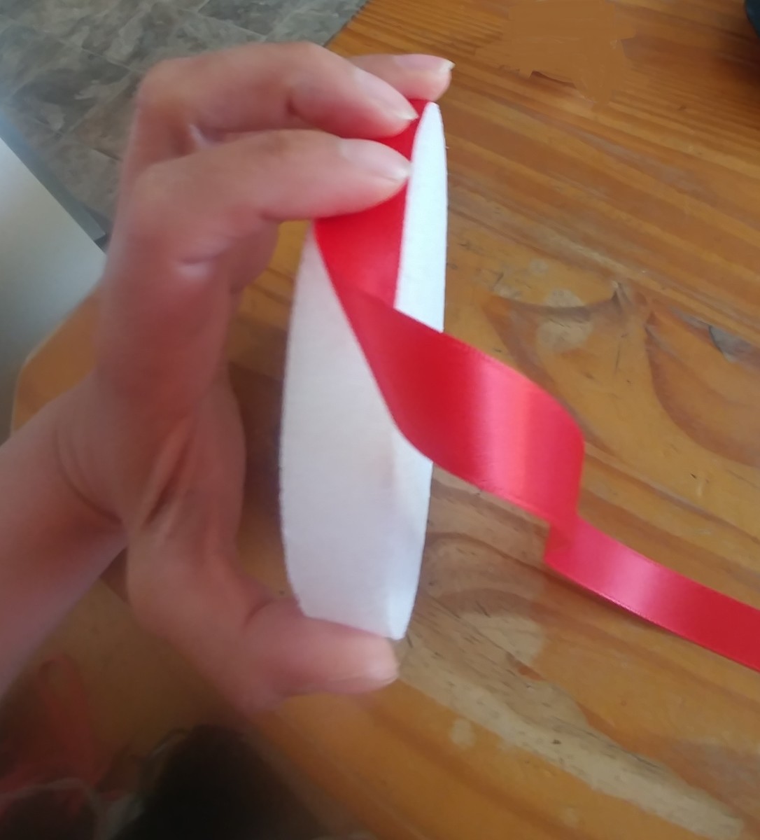 Glue red ribbon around the edge of foam circle.
