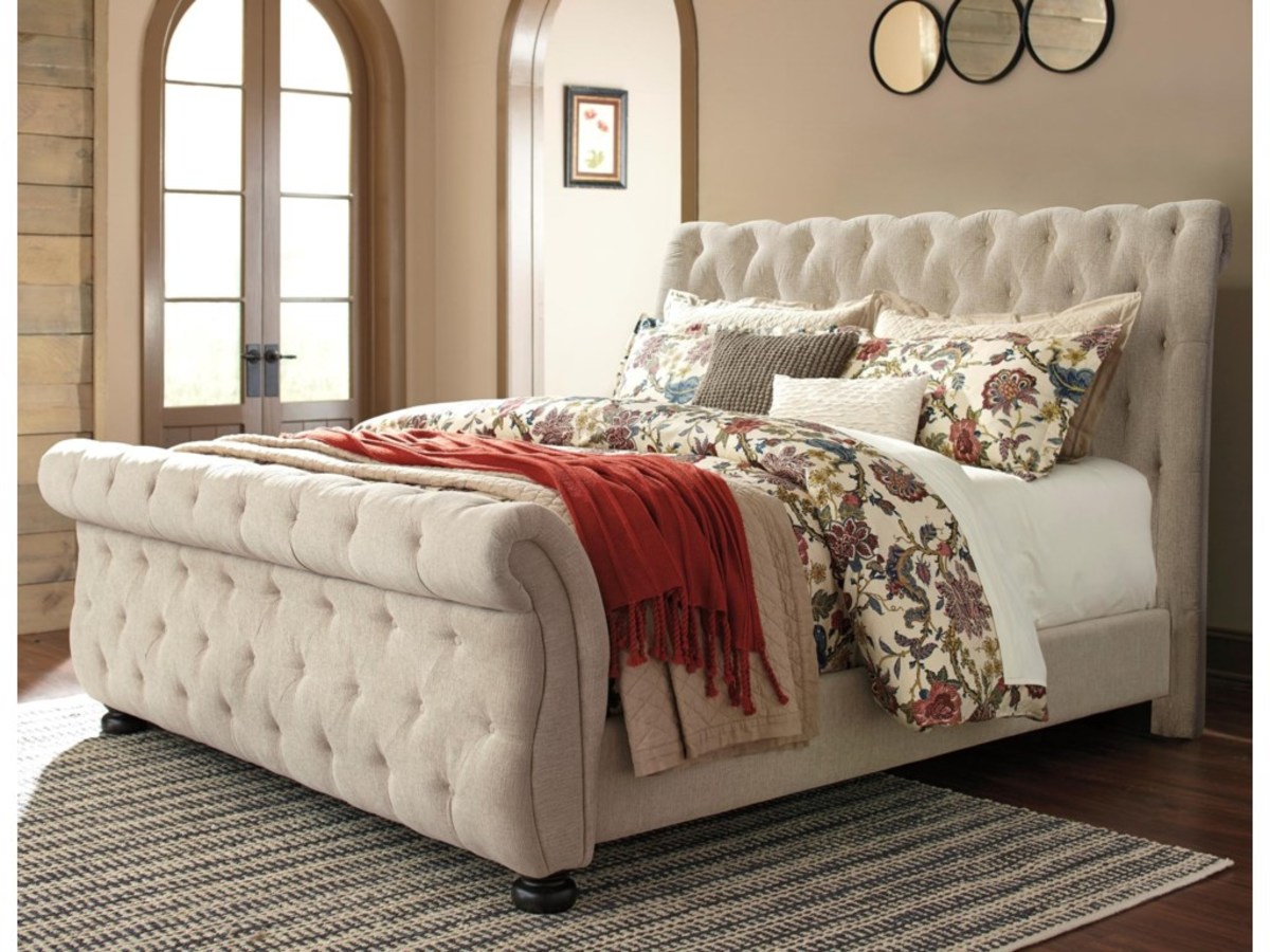 Luxury upholstered sleigh bed. It has the button tufting. Side rails and a classic sleigh headboard and the footboard.