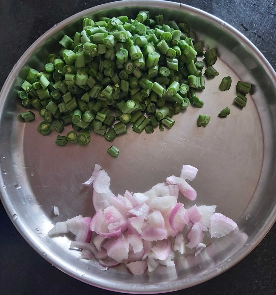 Chop the beans into small pieces or size of your choice. Chopping beans into small size pieces makes them cook faster. Finely chop the onion and set both aside. 
