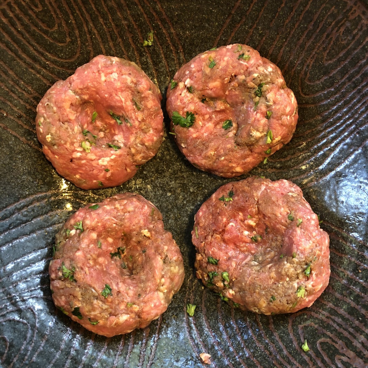 Take time to form the patties to make sure they're all the same size and shape and compact enough to hold together. Indent each burger for better cooking.