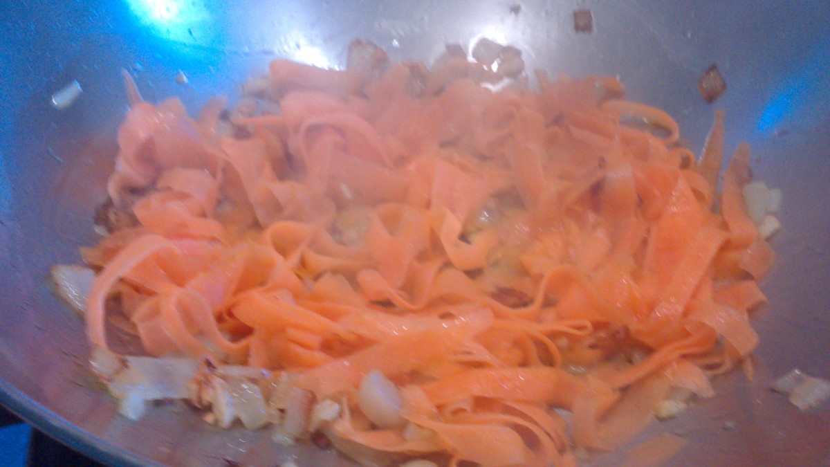 frying the garlic, onions, and carrots