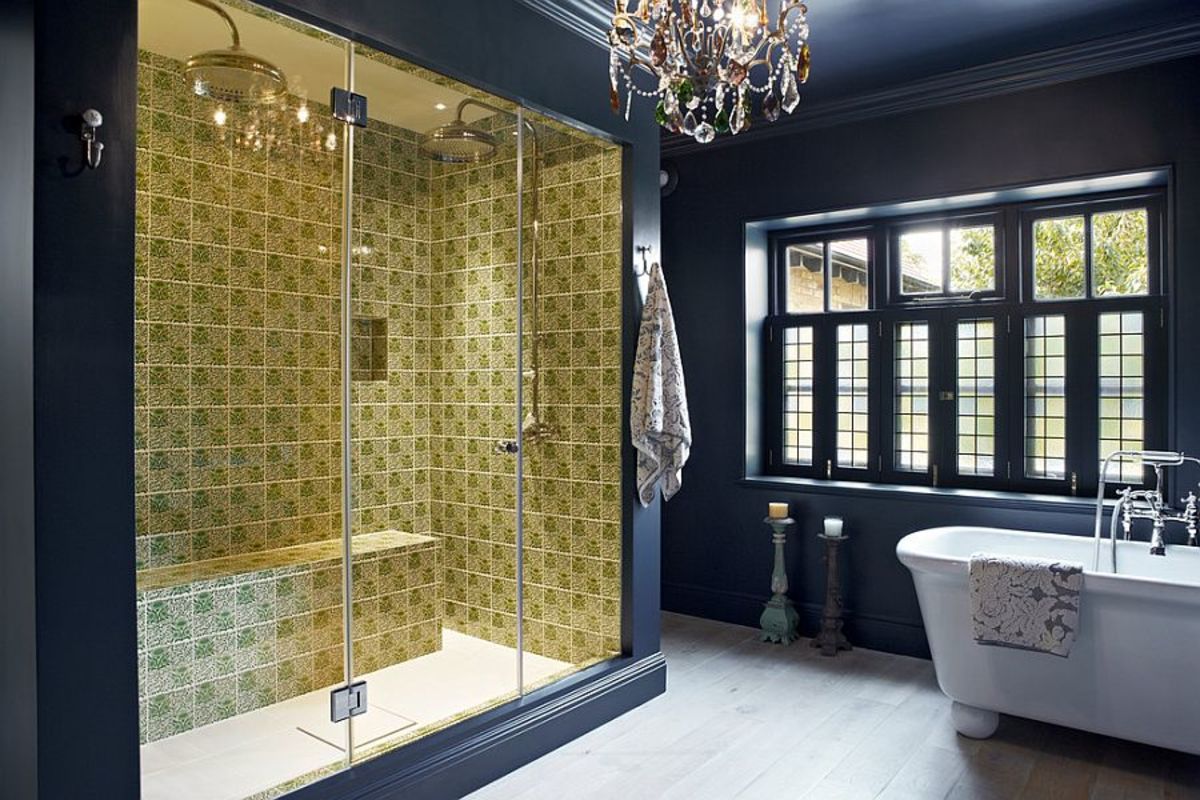 This is the definition of a bathroom inspired by the Chinese Zodiac Rooster. It mixes different shapes, there is a blast of yellow, the giant glass shower doors, and the hanging chandelier. 