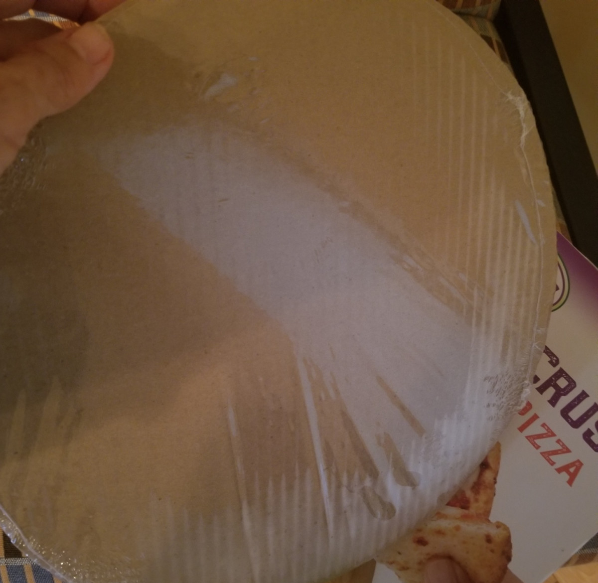 Use a spatula to slide the pizza from the oven to the cakeboard that it is included in the packaging.