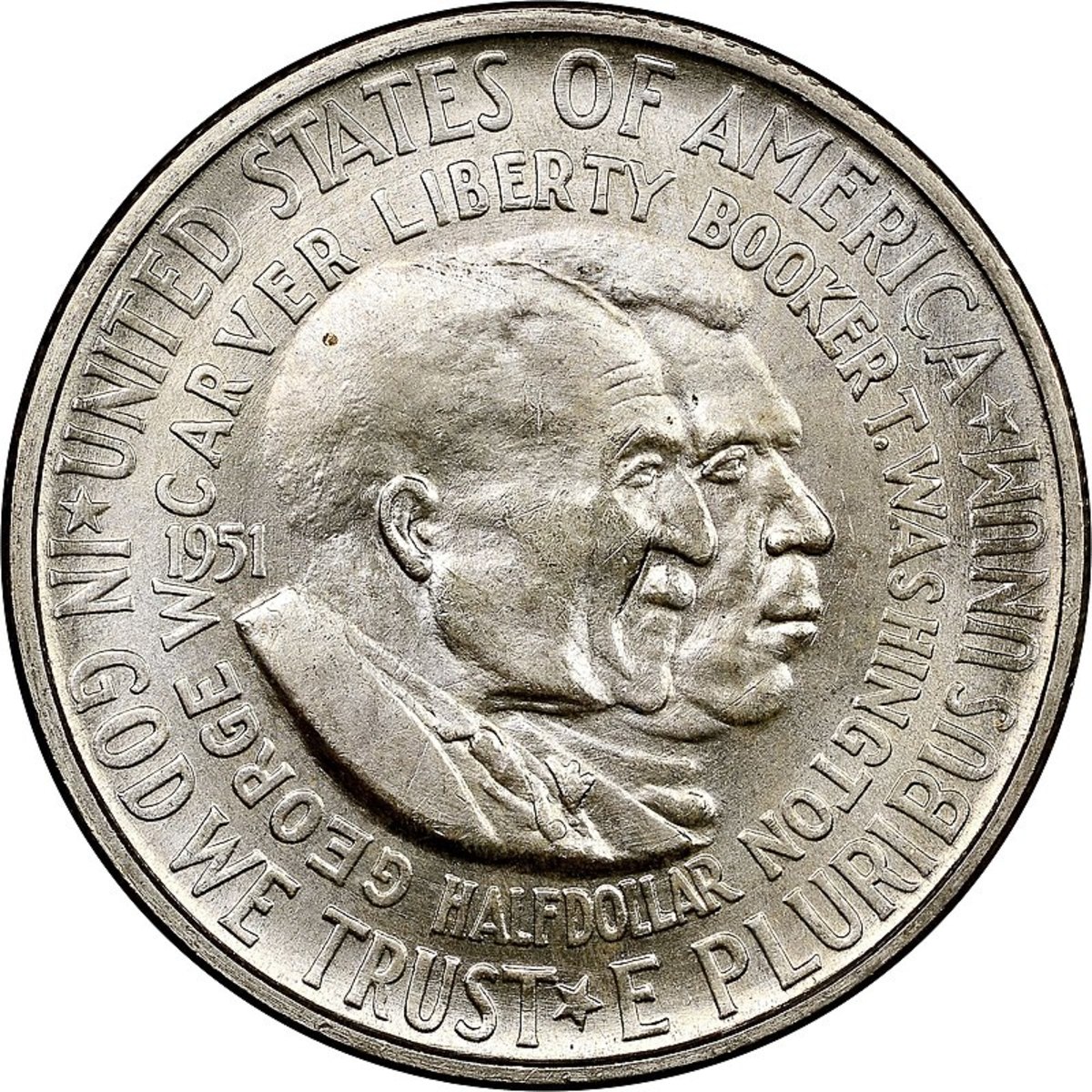 The George Washington Carver-Booker T. Washington Half Dollar depicts side-portraits of George Washington Carver and Booker T. Washington and the reverse shows a simple outline map of the United States. The coin was issued from 1951 to 1954.