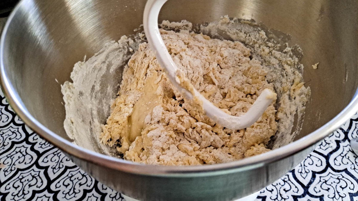 The ingredients have been mixed, and the dough is ready to be kneaded with the dough hook.